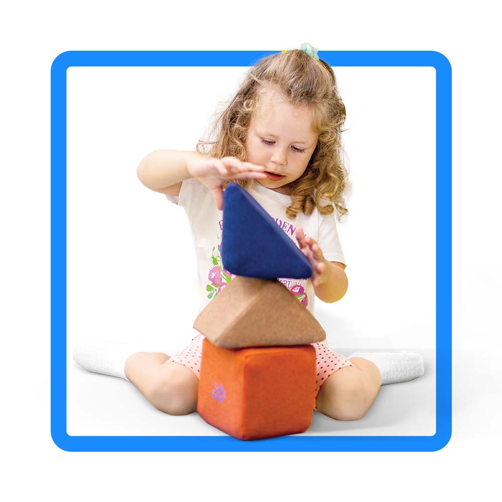 girls manipulating blocks in nursery